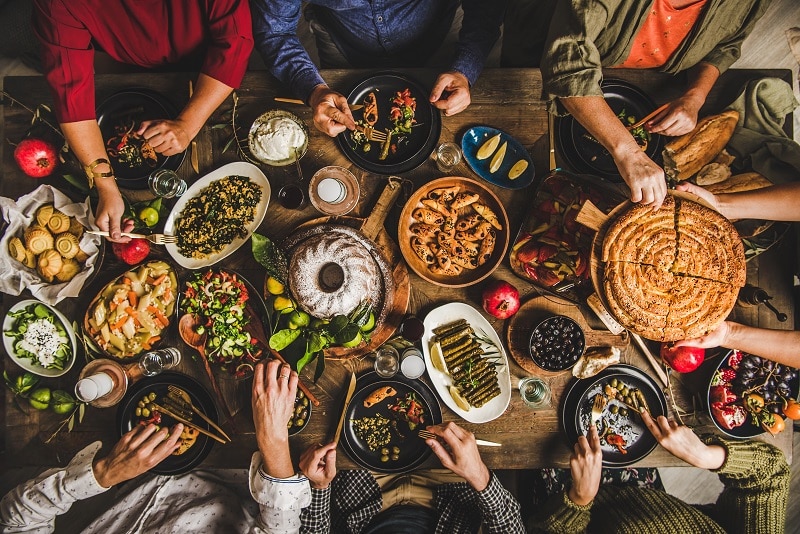 Turkish family celebrating at table with traditional foods and raki